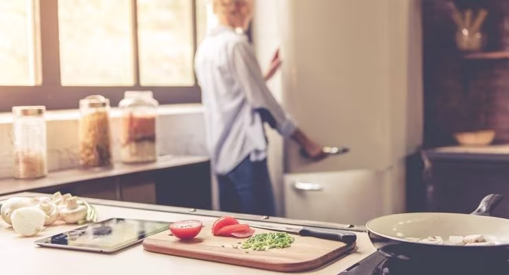 Person looking in fridge whilst cooking