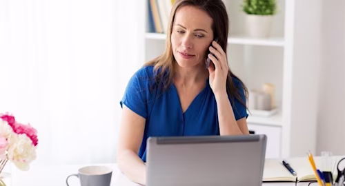 woman on phone and laptop