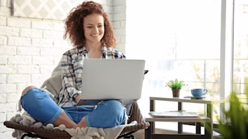 Woman on laptop with MoneySuperMarket logo displayed