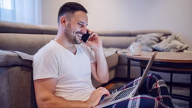 Man on the phone with laptop