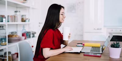 Woman on laptop with MoneySuperMarket logo displayed
