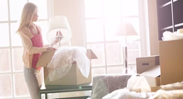 Woman on laptop with MoneySuperMarket logo displayed