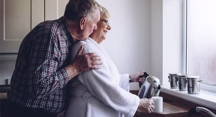 Elderly couple making a hot drink in their kitchen 