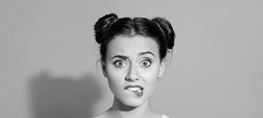 The black and white photo of a confused young woman with dark hair and two buns on her head