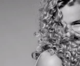 Black and white portrait of a woman with blonde, curly hair