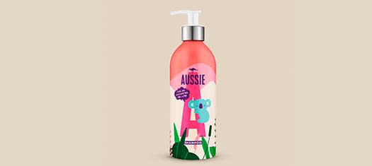 A picture of Aussie Aluminium Shampoo Bottle standing on beige background