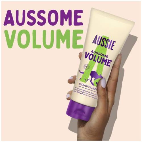 A picture of Aussome Volume conditioner tube in hand and claim: aussome volume