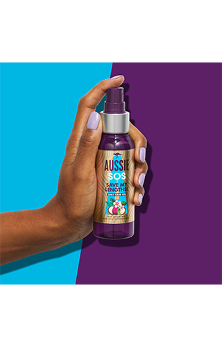 An image of Aussie InHand Oil holded in hand on the purple-blue background