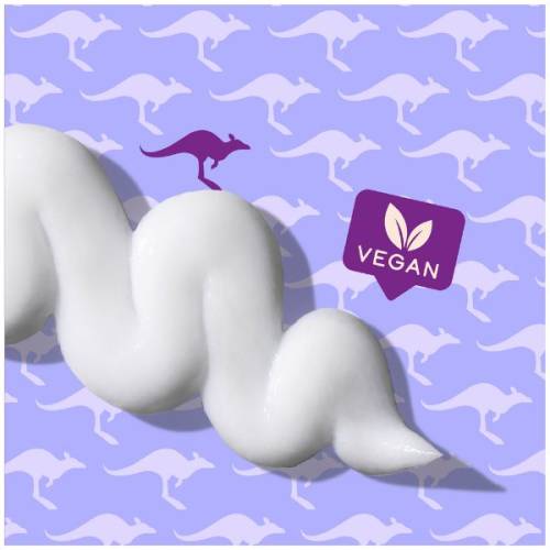 A picture of splash of conditioner and badge saying vegan. 