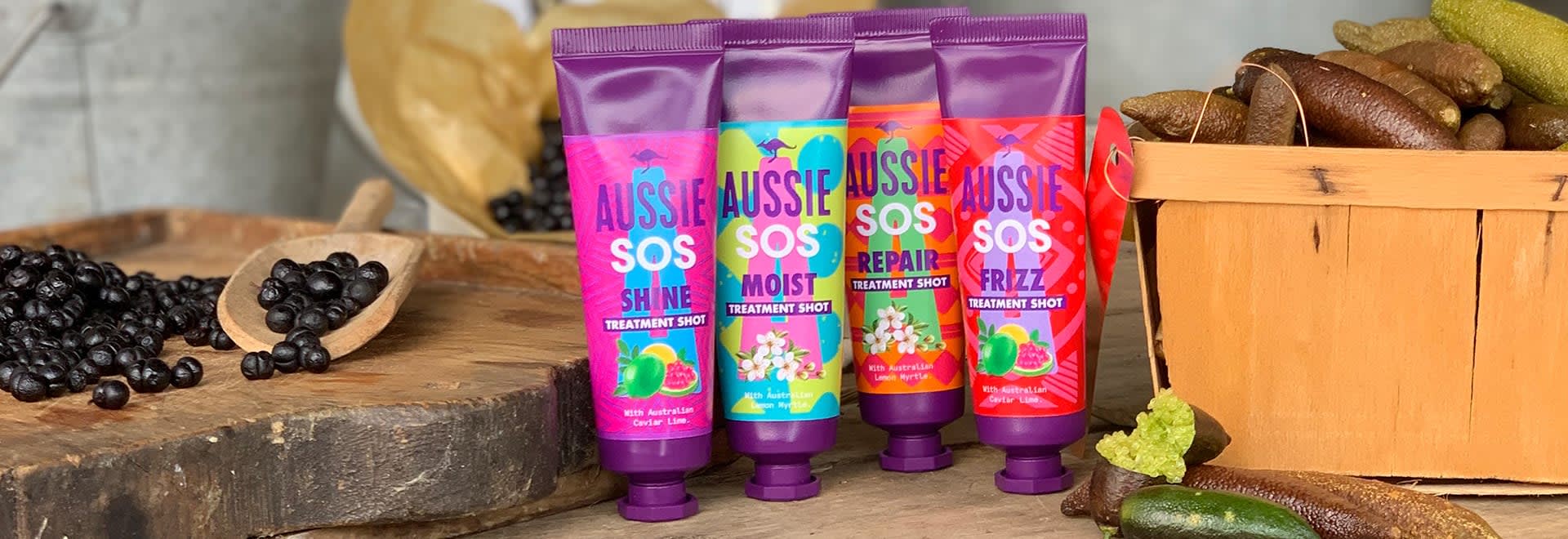 A photo of Aussie products standing one next to each other on a table next to pepperberries in a basket