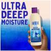 A picture of a conditioner bottle held in hand with a text above: ultra deep moisture.