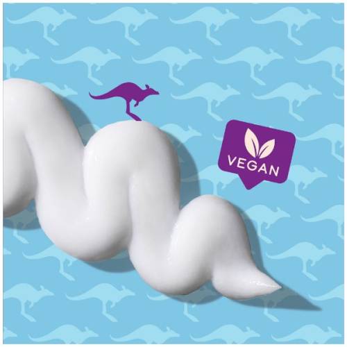 A picture of splash of conditioner and badge saying vegan. 