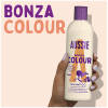 A picture of bonza colour shampoo Bottle in hand with claim Bonza Colour