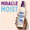 A picture of leave in conditioner  held in hand with a text above: Miracle Moist.