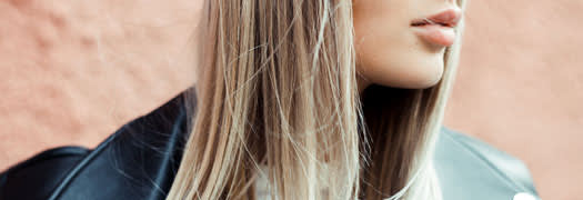 A photo of half of woman's face who has long blonde straight hair