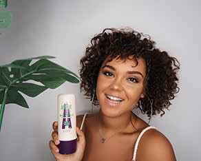 A photo of a girl presenting one of Aussie products