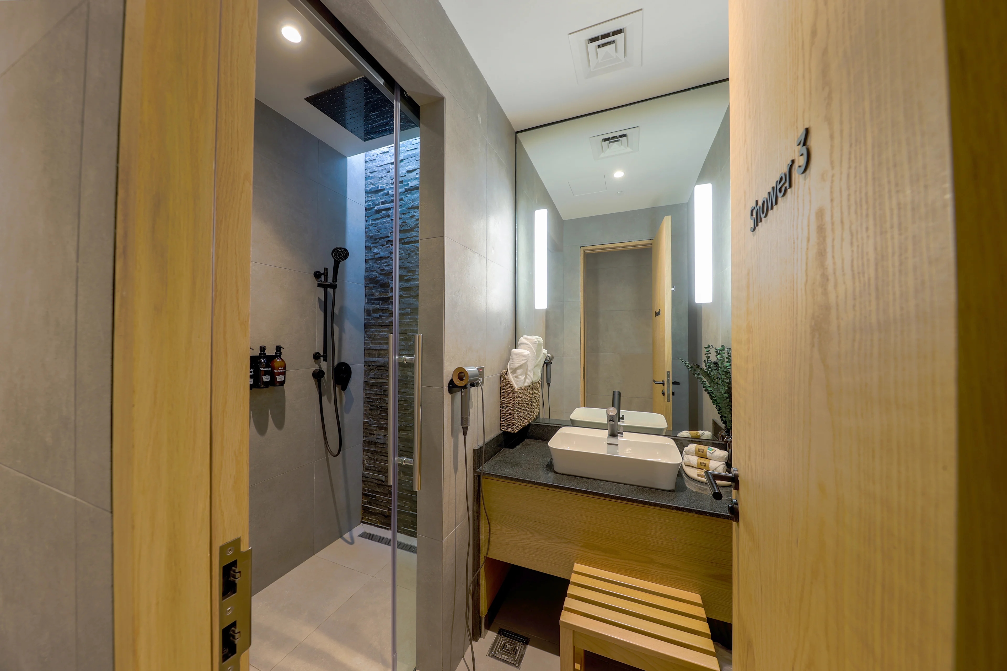 Shower area at Doha North with multiple private stalls and bright, clean interiors.