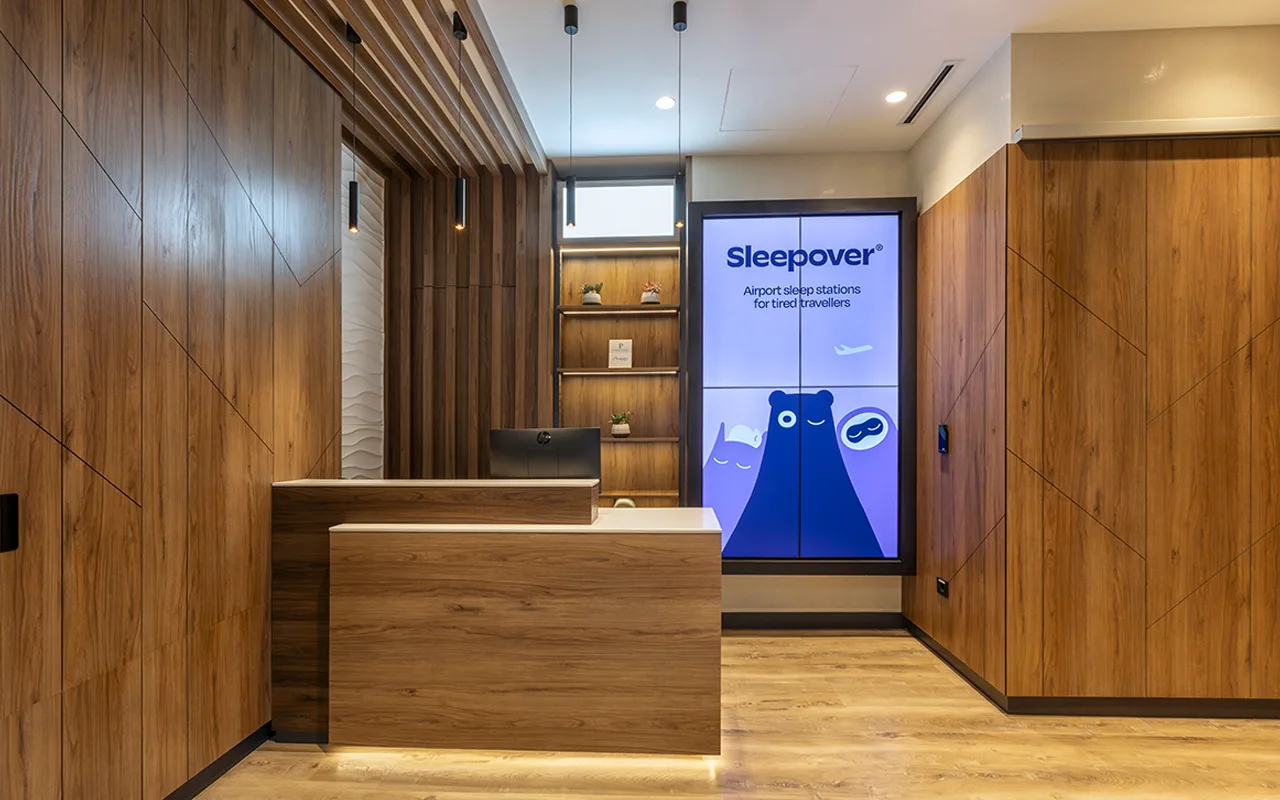 Reception desk at Lima Airport Sleepover facility with signage and service counter.