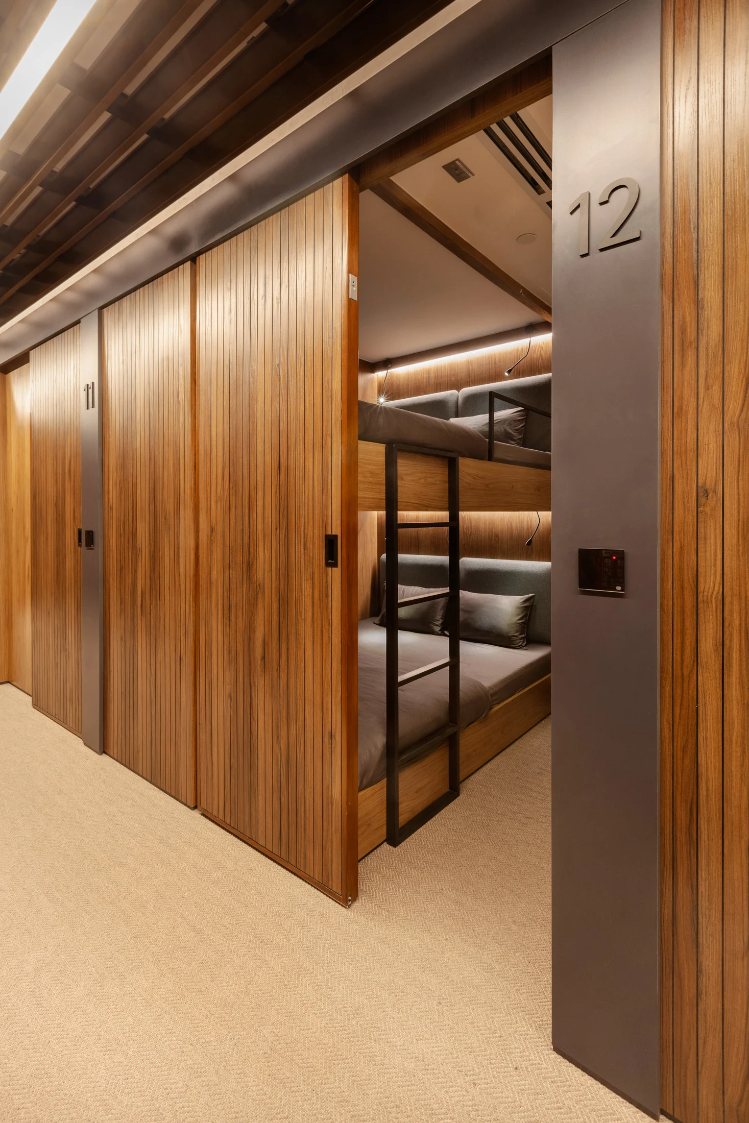 Bunk bed sleeping pod at Lima Airport with privacy panels and integrated lighting.