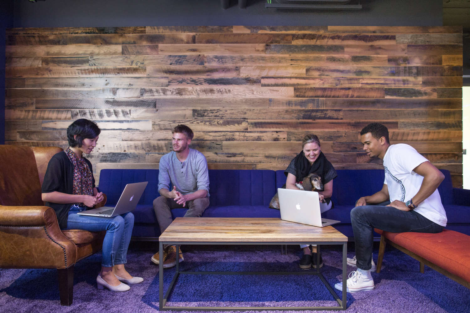 Lyft employees having a meeting on one of the couches at Lyft HQ.