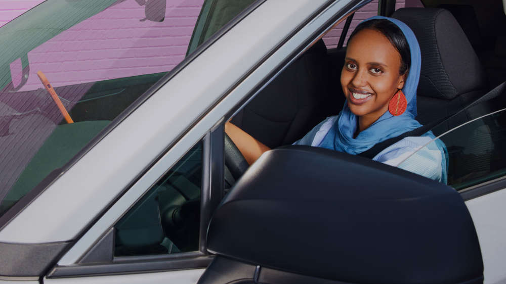 Image of a woman sitting in the driver's seat of a car