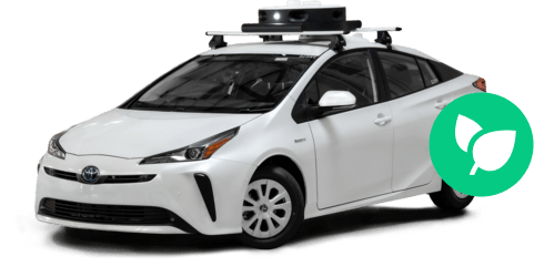 A white sedan with a LIDAR sensor on the roof