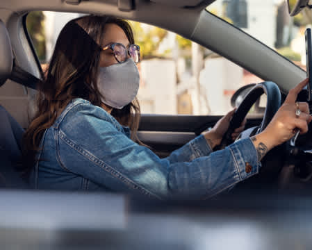 woman in mask using driver app
