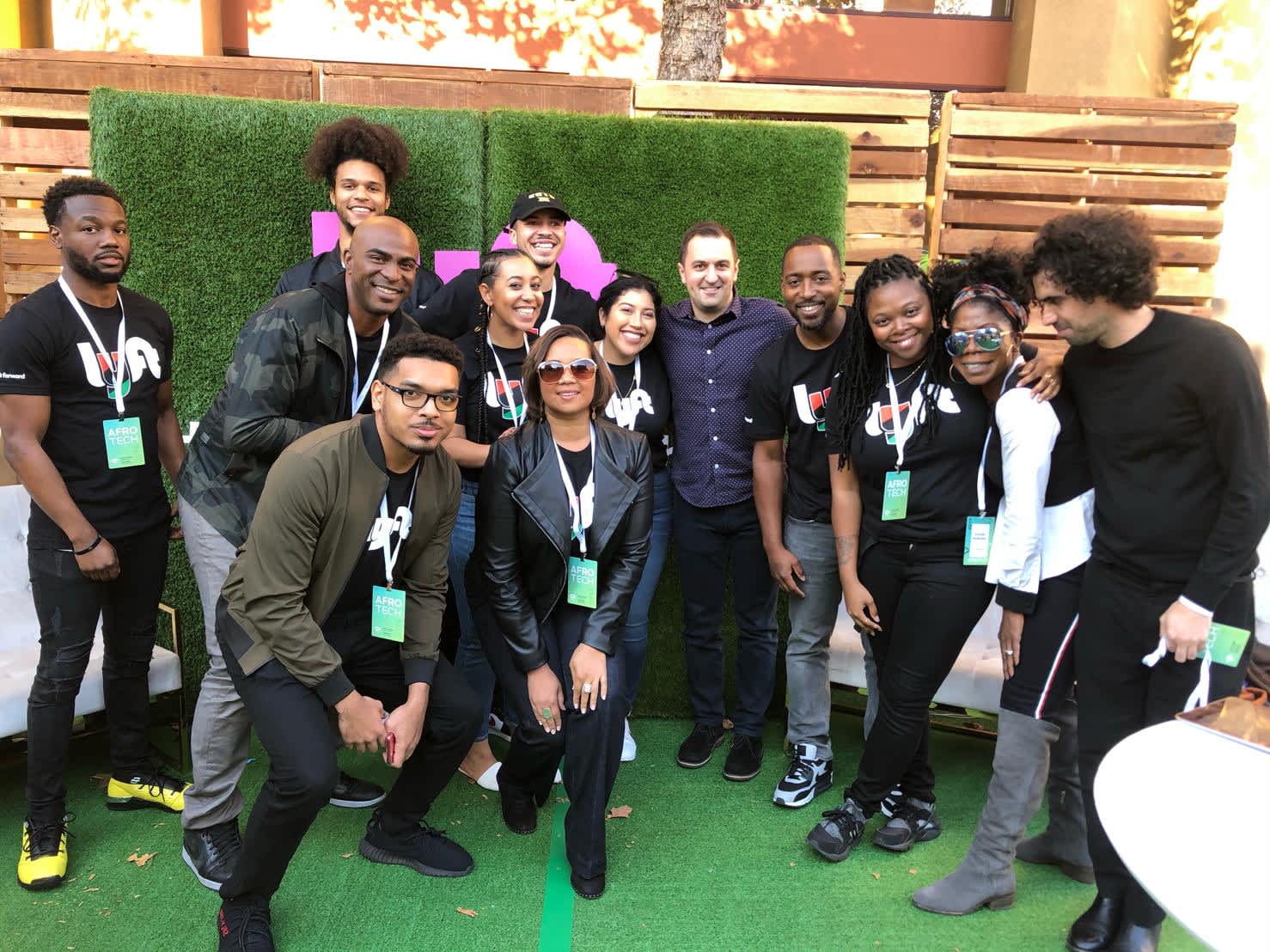 Jacob poses for a photo with a group of Black tech workers and Lyft Founder John Zimmer at AfroTech 2019.