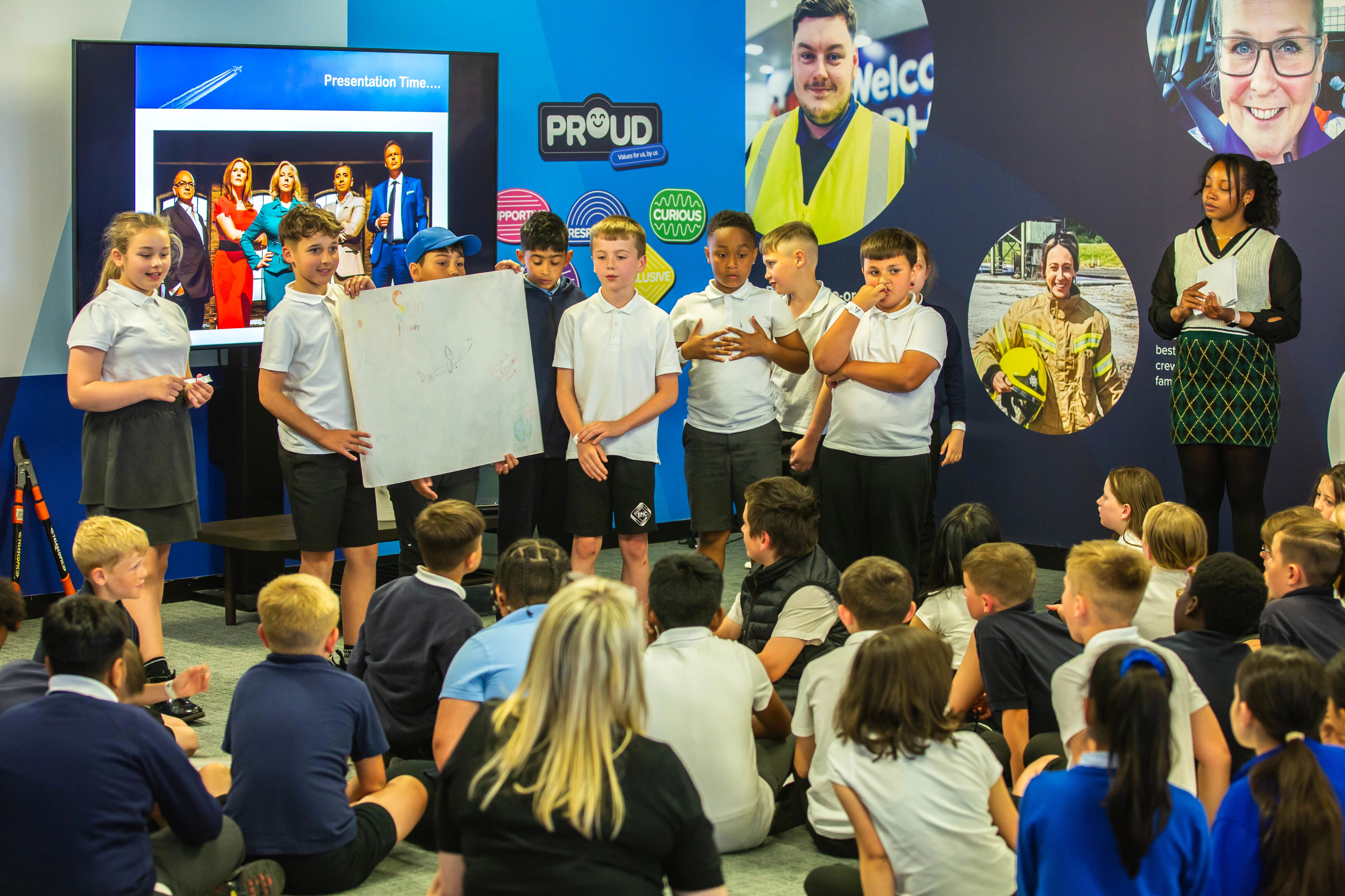 Children stood up presenting to other children at a BHX Educational Visit