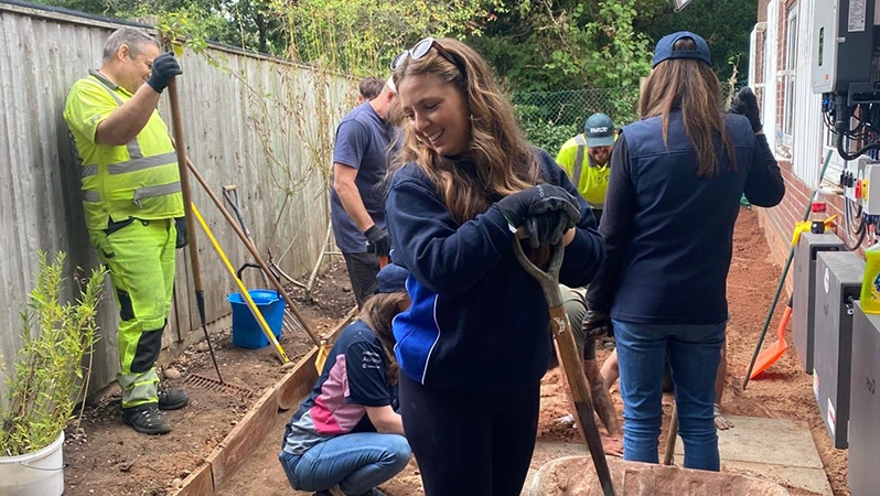 A picture of the Airfield Engineering Team at Birmingham Airport volunteering, in a outdoor setting where you can see shovels and wheelbarrows