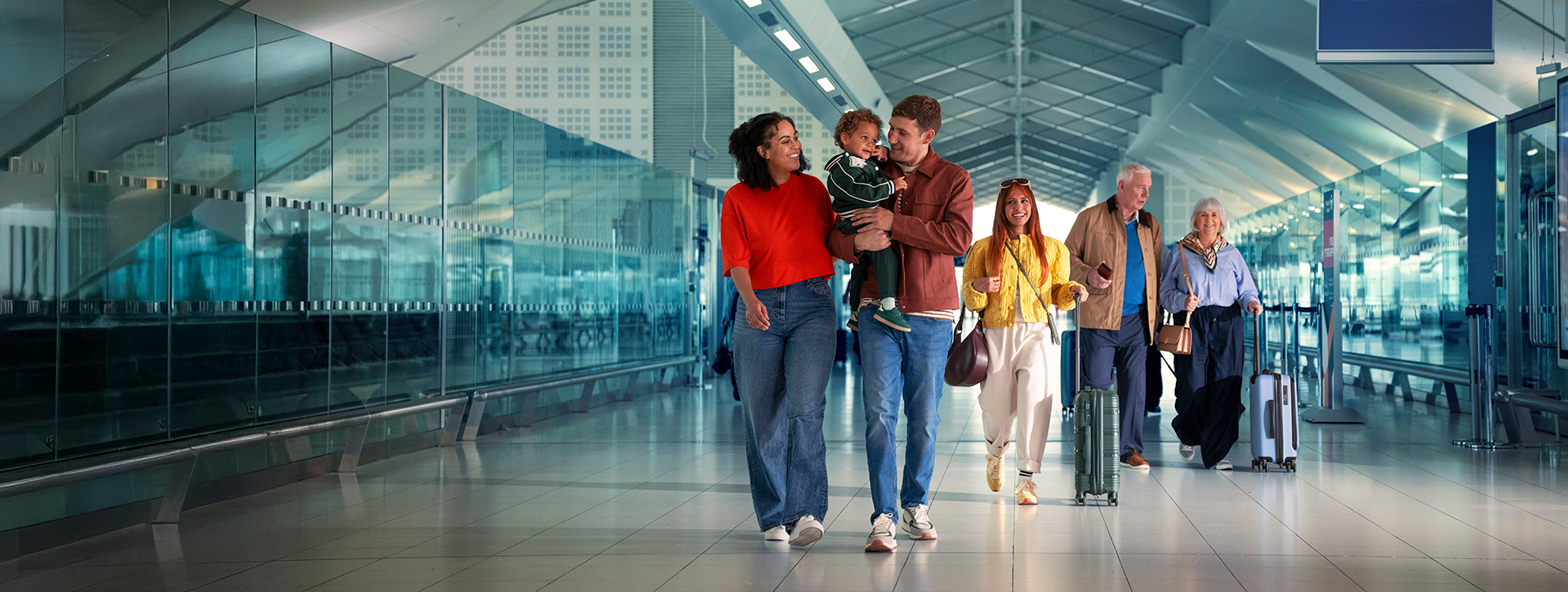 A family of three, an influencer and a couple walking along Birmingham Airport's (BHX) International Pier