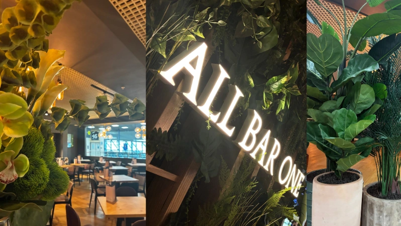 The interior of All Bar One at Birmingham Airport - large clock on the wall with the kitchen right behind