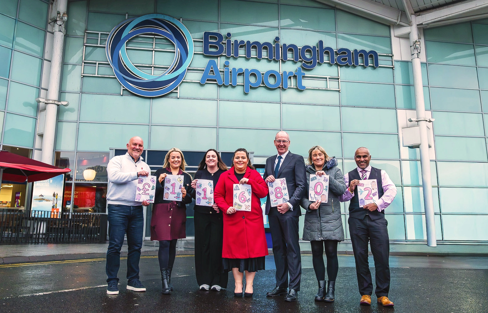 BCH and BHX employees holding amount raised for the charity in year one of partnership