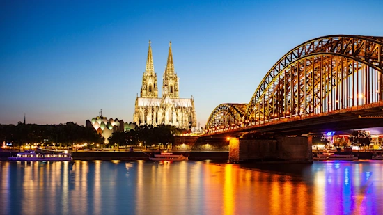 Cologne Cathedral and Hohenzollern Bridge through Rhine river in Cologne, Germany