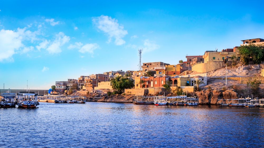 Egypt - Wooden boats carrying passengers docked along the Nile River at the Temple of Philae in Aswan, Egypt, North Africa - Landscape