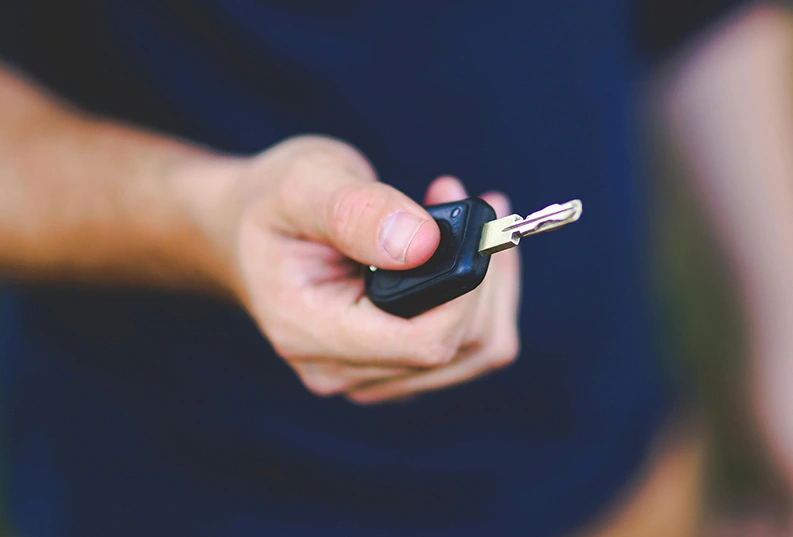 A stock image of a hand holding a set of car keys.