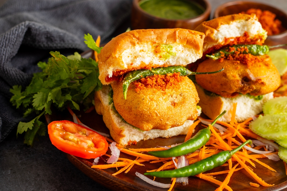 Mumbai - Vada Pav is a popular Indian street food, featuring a spicy potato fritter (vada) inside a bun (pav), served with chutneys Landscape