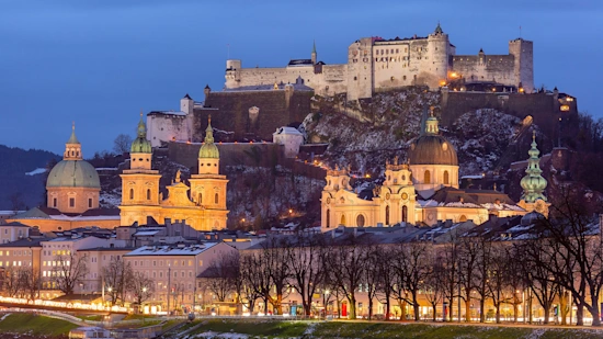 Sunset view of Salzburg with Hohensalzburg Fortress and Salzburg Cathedral, Austria.