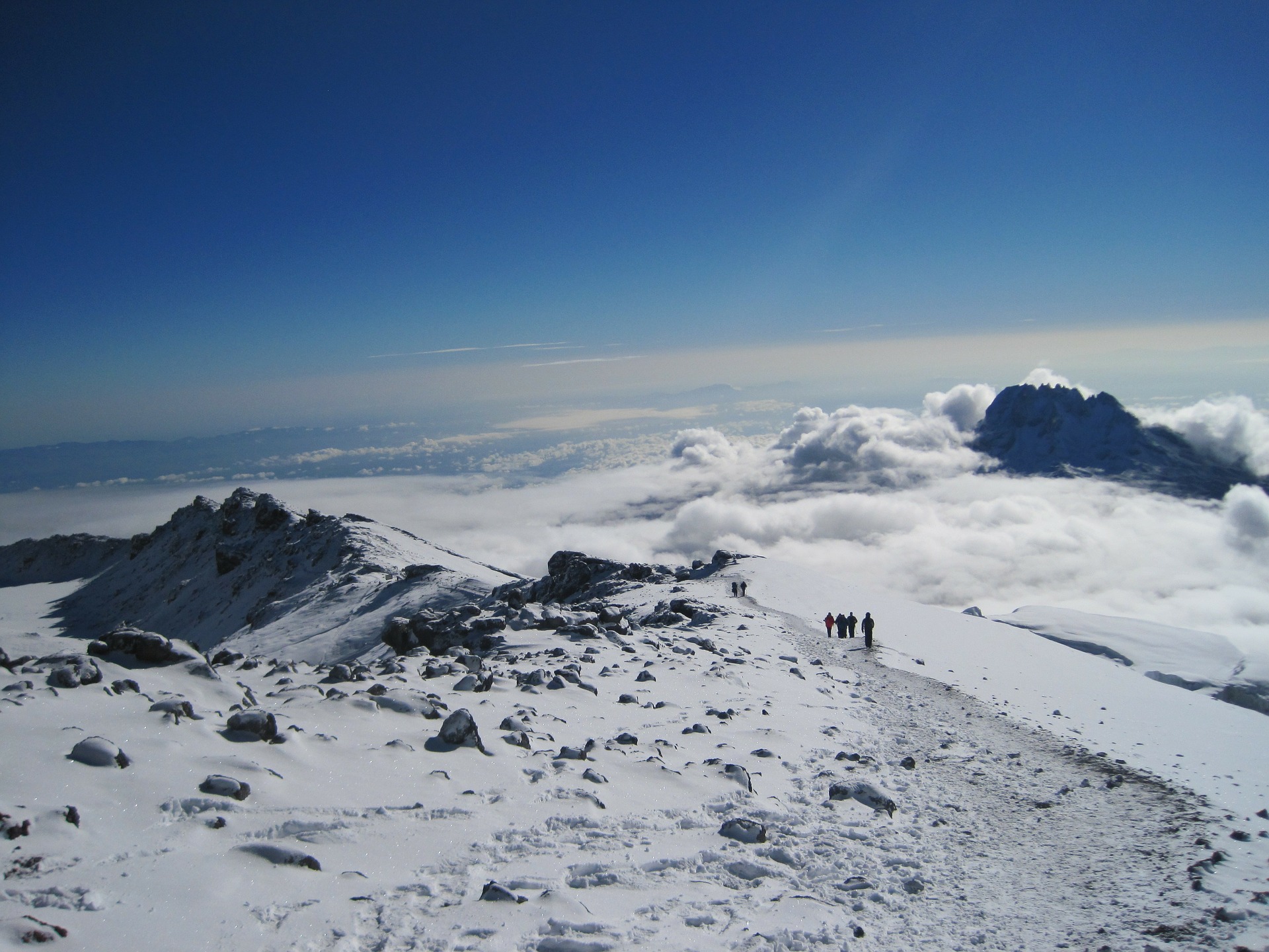 Trekkers descending after the summit with the glorious view of Mawenzi peak.