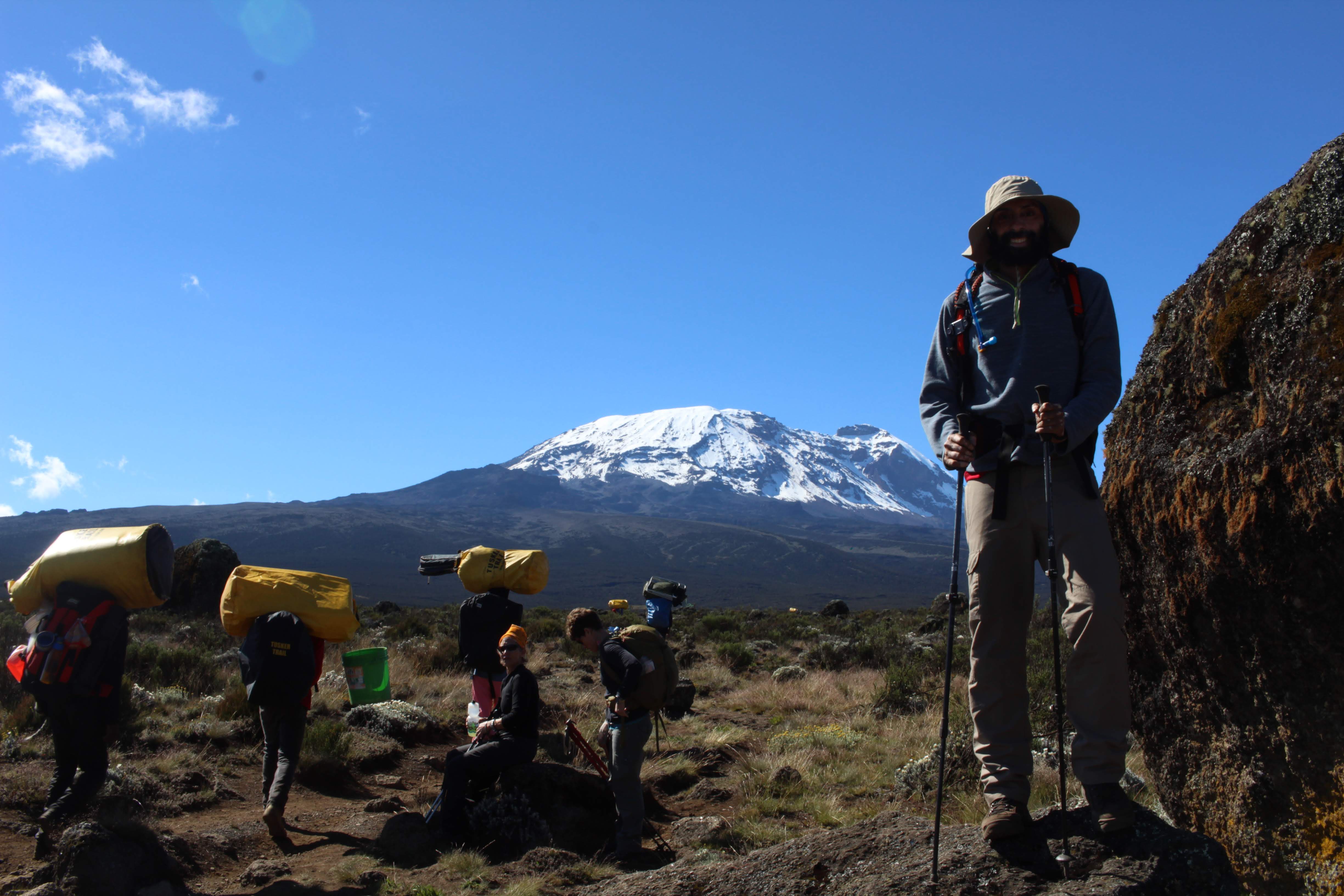 Trekkers pose with the glorious Uhuru peak in the backdrop! 
