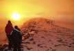 Trekkers enjoying the blissful sunrise above the clouds