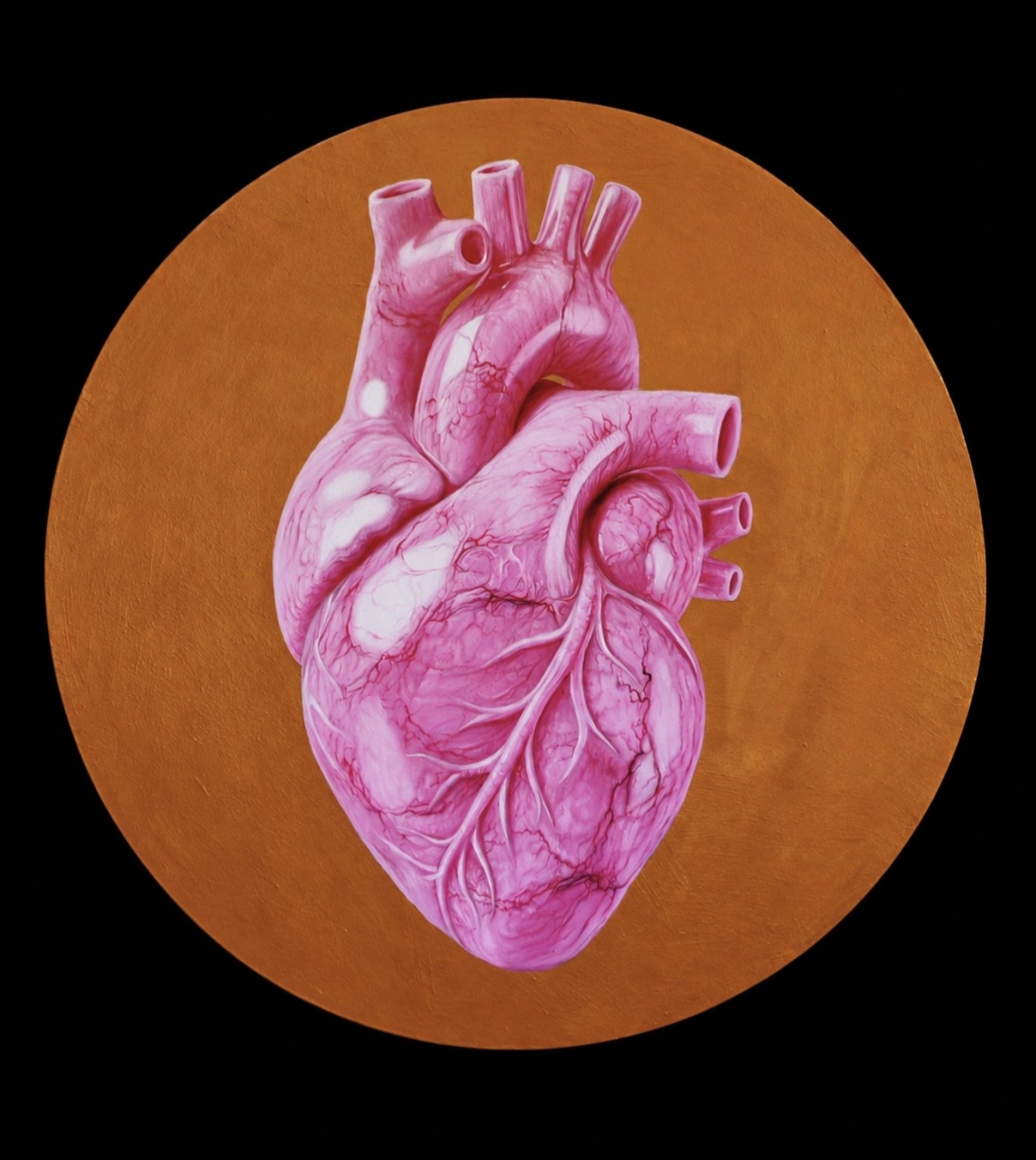 Corazón escultórico de mármol rosa sobre fondo circular dorado.