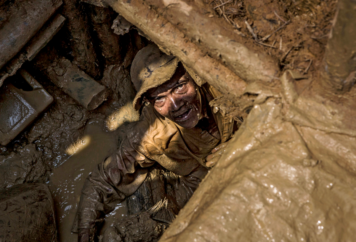 A miner looks up from a muddy hole where he's looking for diamonds. Skydiamonds are zero-exploitation products