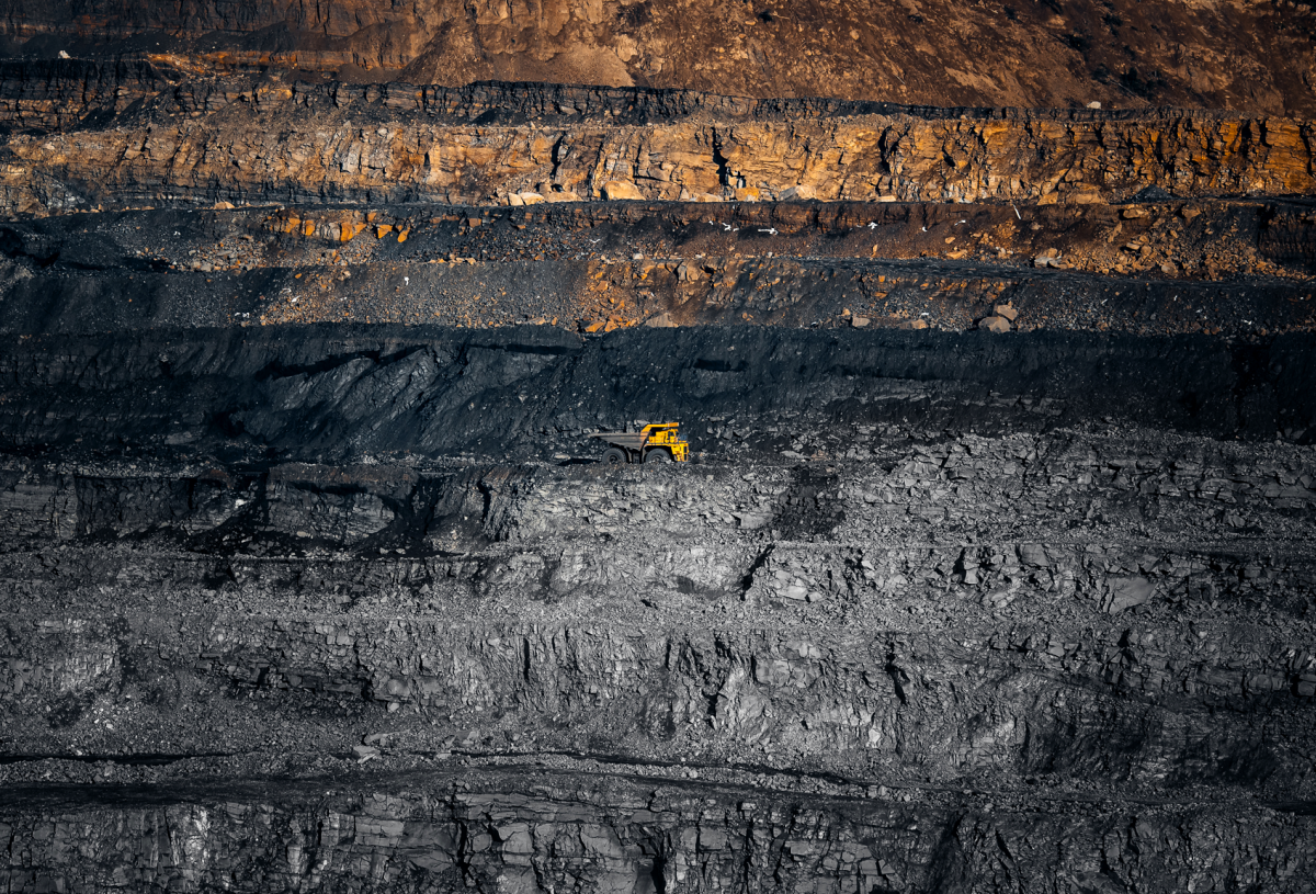 A giant hole created by a diamond mine dwarfs a yellow dump truck. Skydiamond's eco-friendly diamonds don't lead to environmental damage