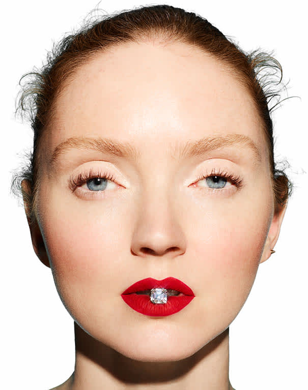 Model Lily Cole holding an Asscher cut Skydiamond in her mouth. 