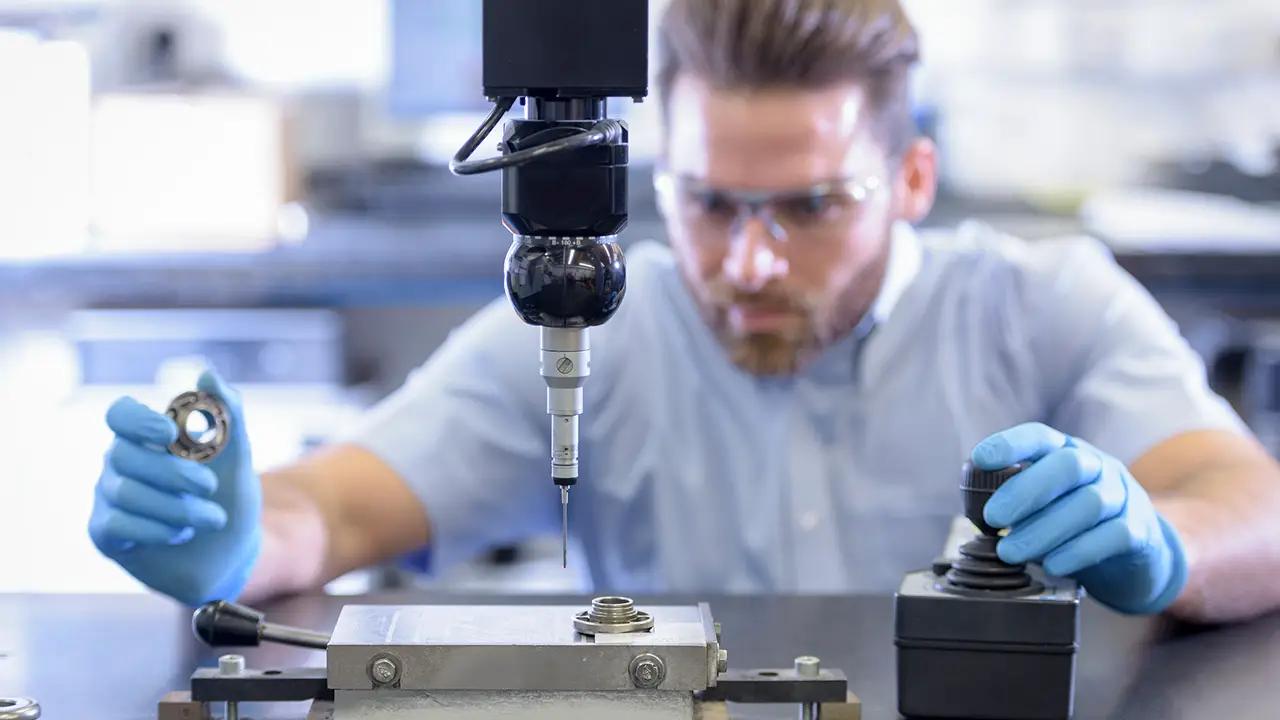 Male worker working on machinery; heavy equipment manufacturer