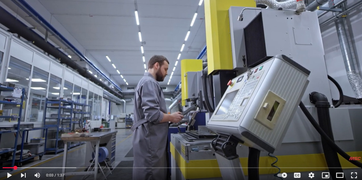 Male metalworking employee working on large equipment