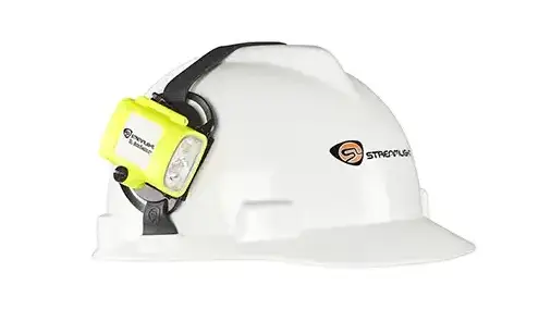 White hard hat with yellow and black headlamp attached to front, featuring Streamlight branding on helmet side.