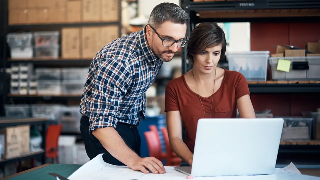 Man and woman looking at laptop screen
