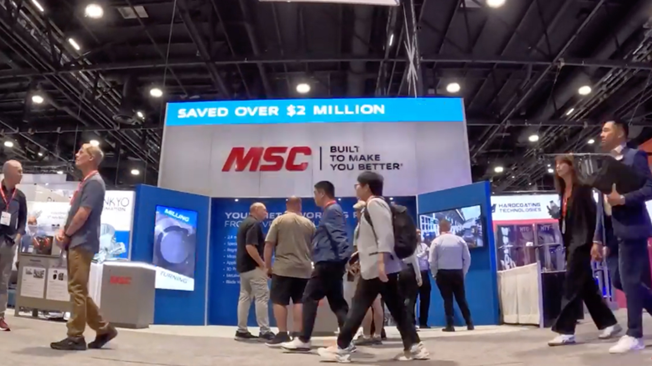 MSC Industrial Supply trade show booth with blue and white branding, large overhead sign, and attendees walking by.